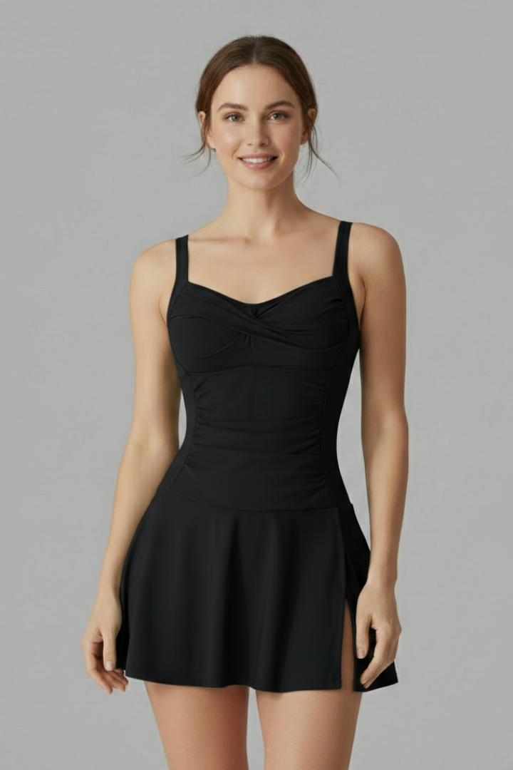 Woman in skirted one-piece swimsuit displayed on gray background
