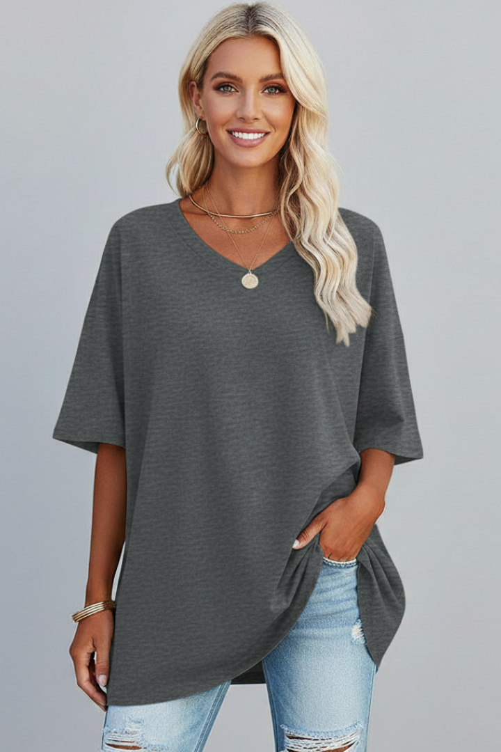 Model in gray v-neck short sleeve top gray background photo