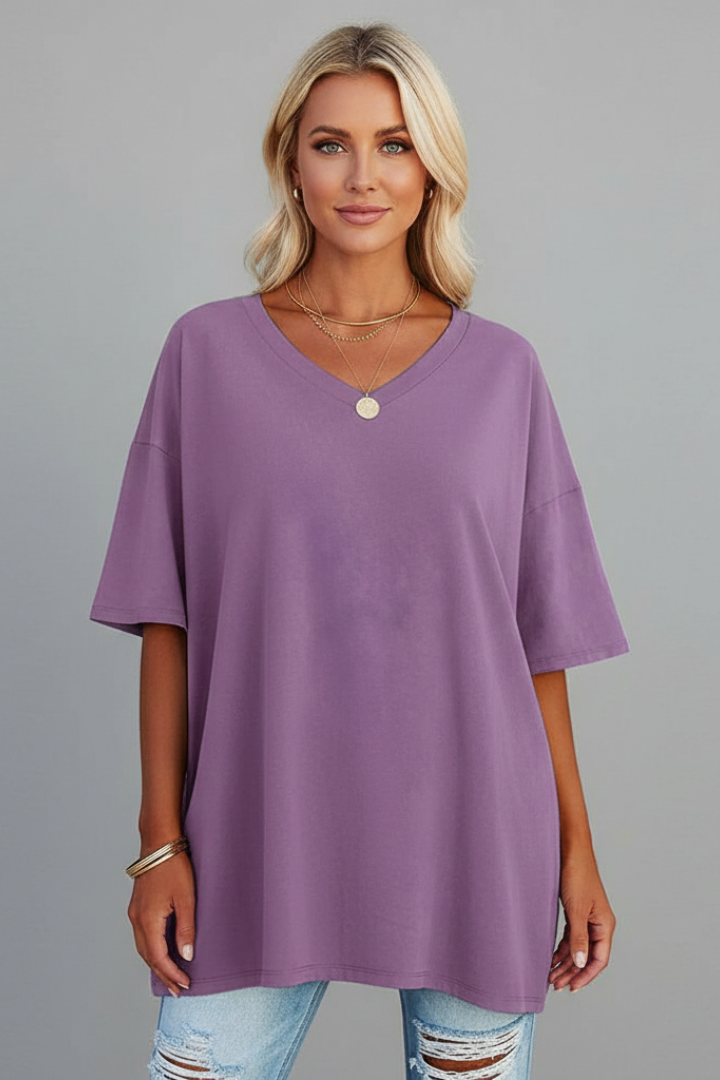 Woman in v-neck short sleeve tee front view gray background