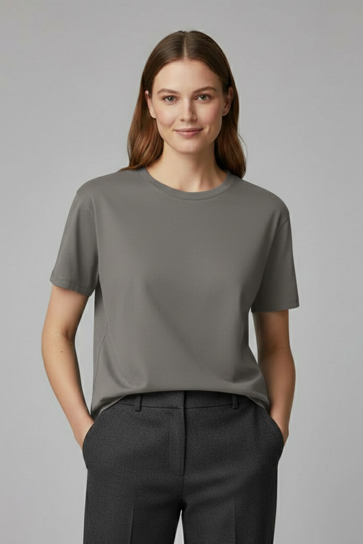 Front display of minimalist relaxed woman wearing fashion grey shirt