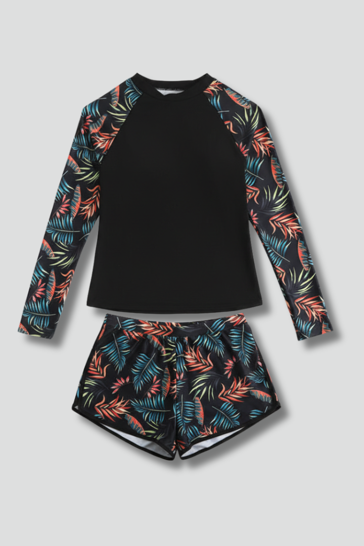 Clean shot of long sleeve top and short swim seat in gray background 