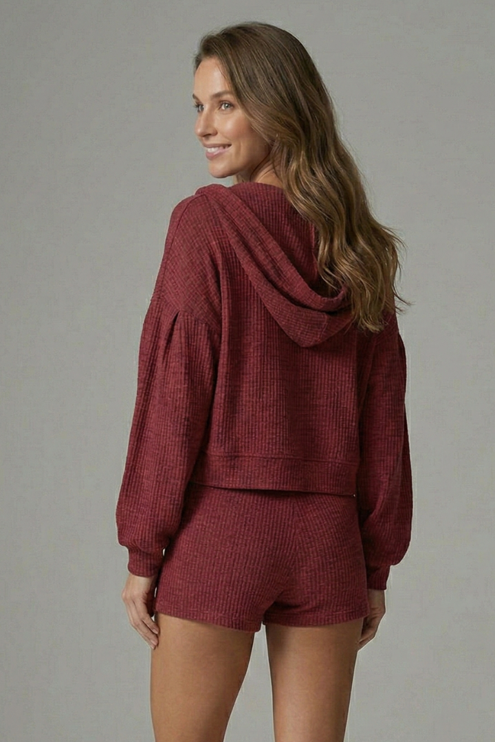 Woman showing back angle of ribbed hooded set gray background