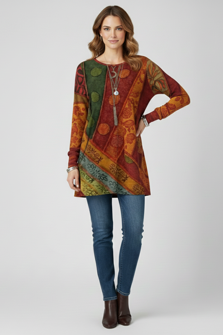 Long sleeve patterned geometric top paired with denim jeans and leather boots