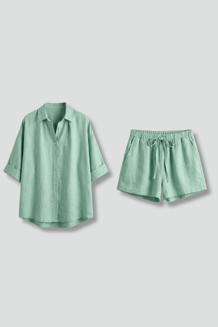 An elbow-sleeve shirt and shorts set, plain gray background.