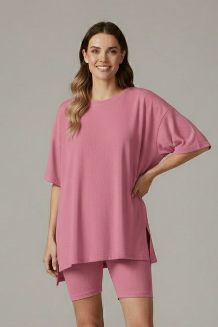 Relaxed pose two piece pink set in gray background