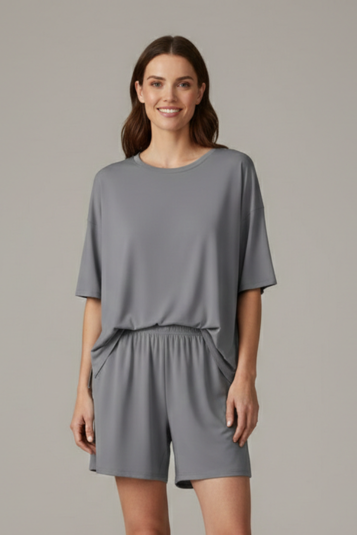 Model front view loose outfit gray background
