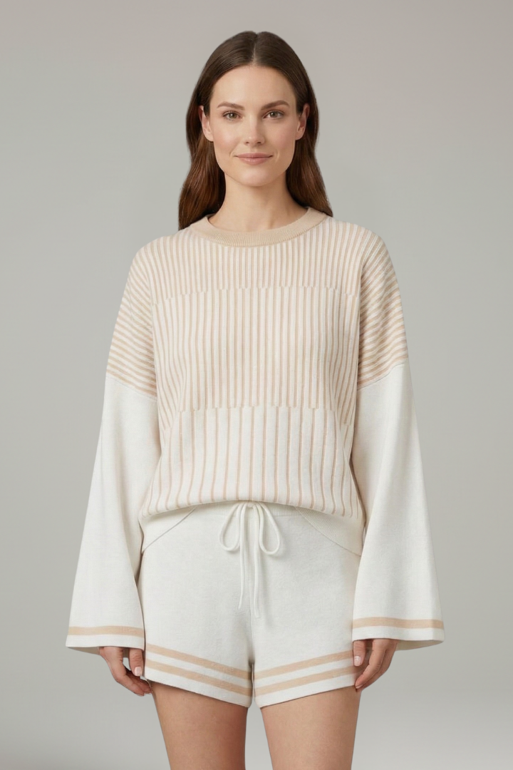 Female model wearing striped co-ord set in front view angle with gray plain background