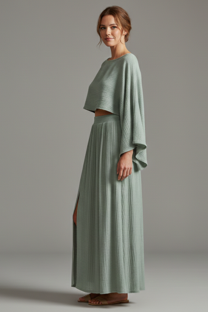 Side view model in high slit maxi skirt and cropped top