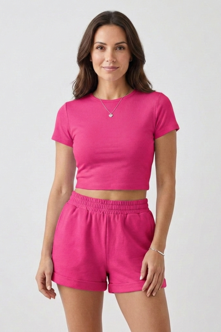 Matching crop top pink shorts and top outfit on model