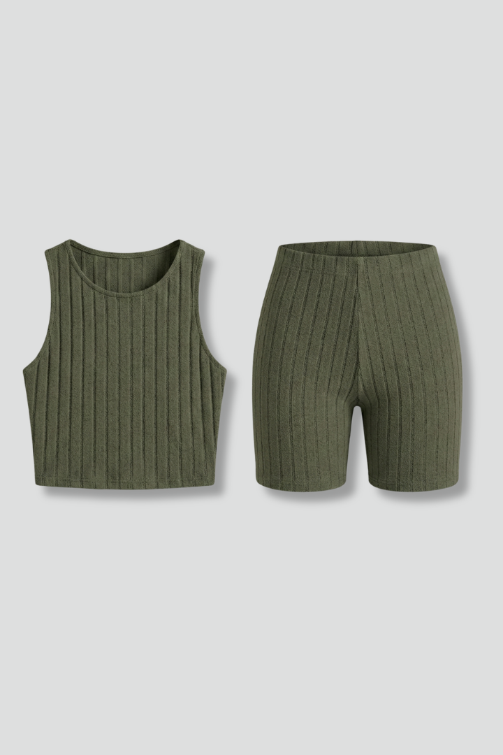 Woman wearing ribbed crop top and shorts on gray background