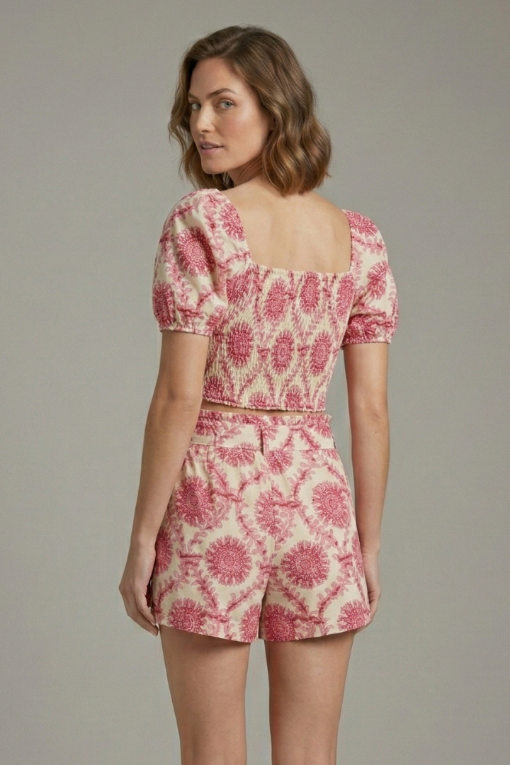 Female model back angle in matching floral summer outfit.