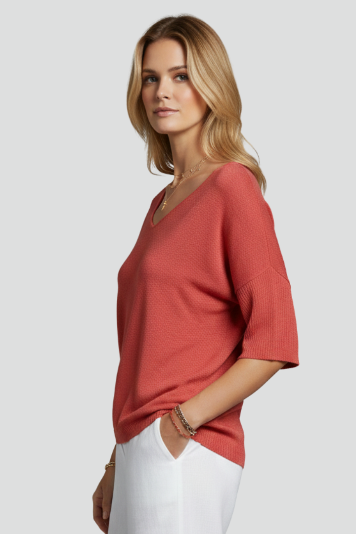 Textured coral shirt with V neckline side pose