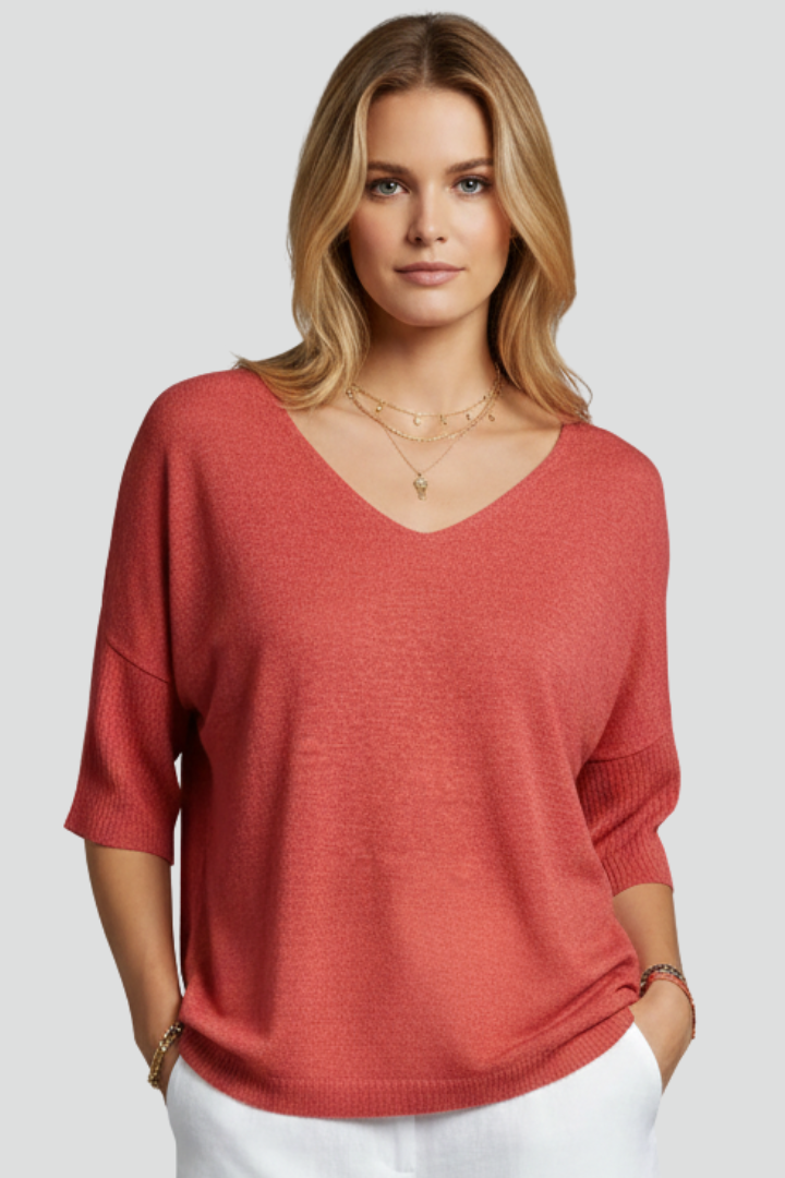 Coral textured blouse side view on gray background