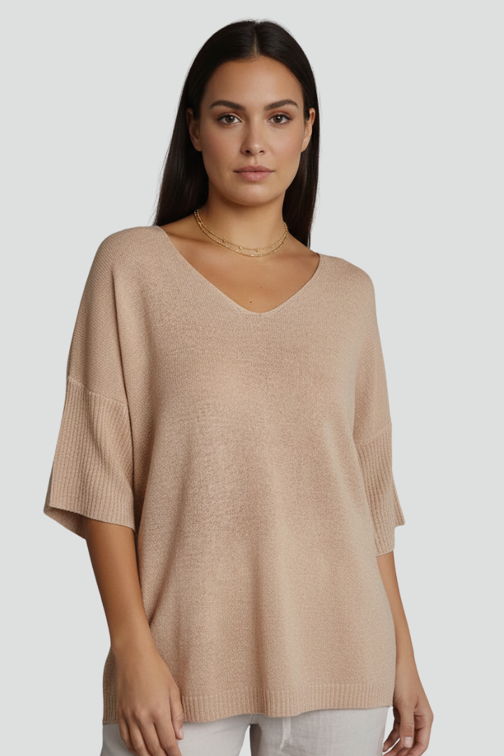 Textured beige blouse photographed in front angle view