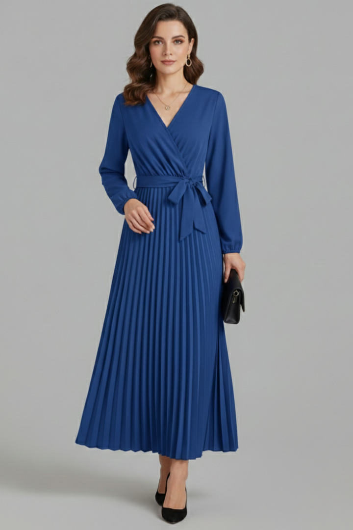 Model standing full length pleated dress gray background