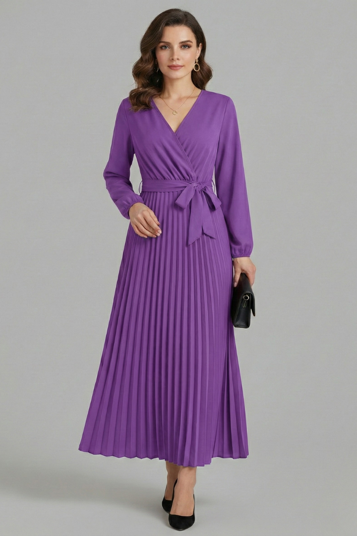 Woman posing flowing pleated purple maxi dress gray background