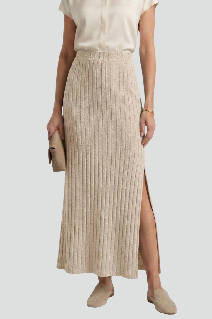 Model front angle wearing long ribbed skirt in gray background