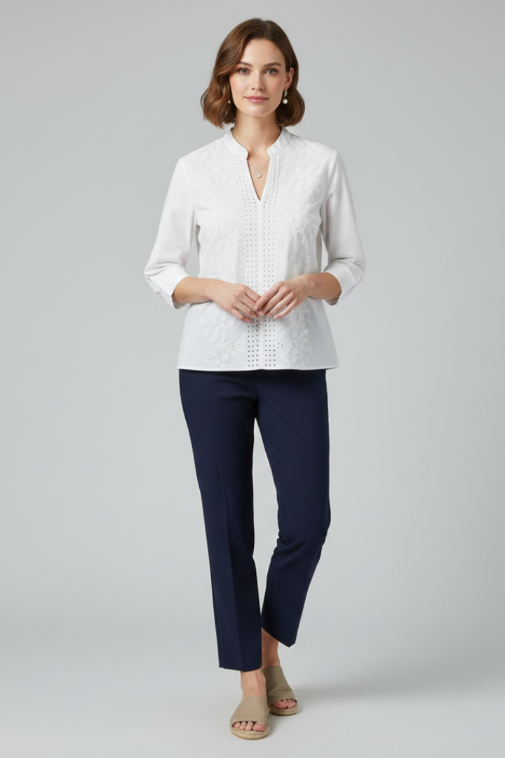 Woman wearing white woven blouse front studio pose.