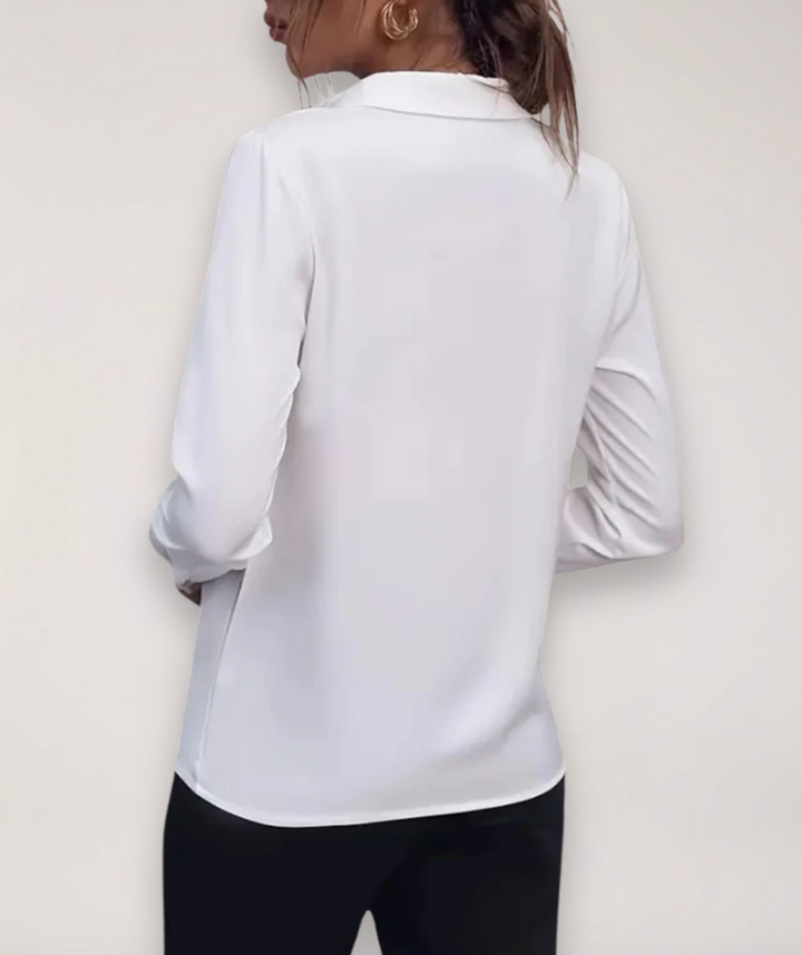 Refined button-up work blouse displayed against a plain background with crisp tailored detail, back view