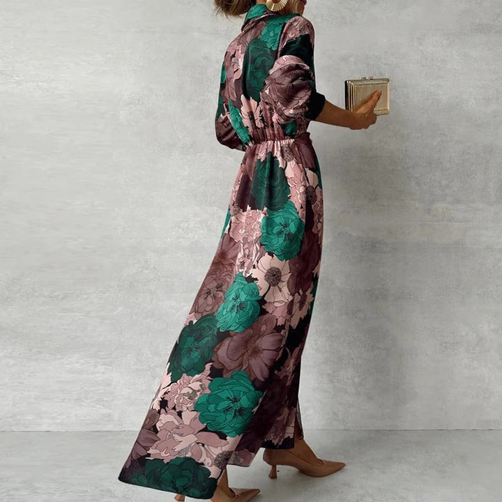 Female model in a botanical print button-front maxi dress on a plain background.