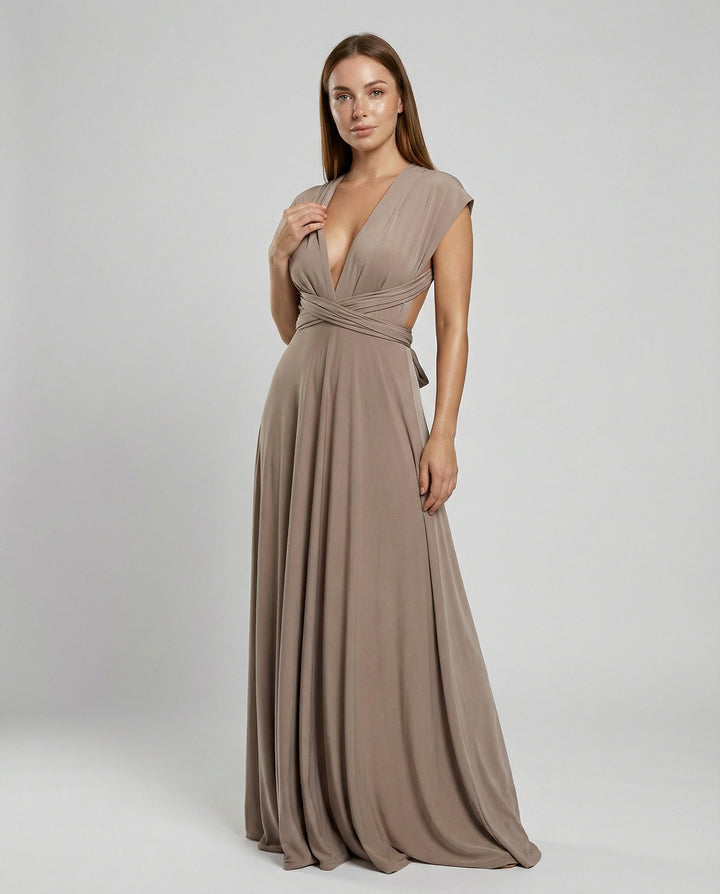 Female wearing a flowing multiway maxi dress styled with wrap straps against a plain background.