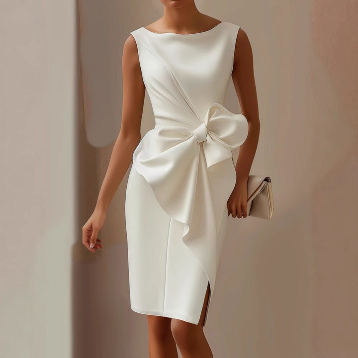 Woman posing in a fitted sleeveless midi dress with draped detailing on a plain background.