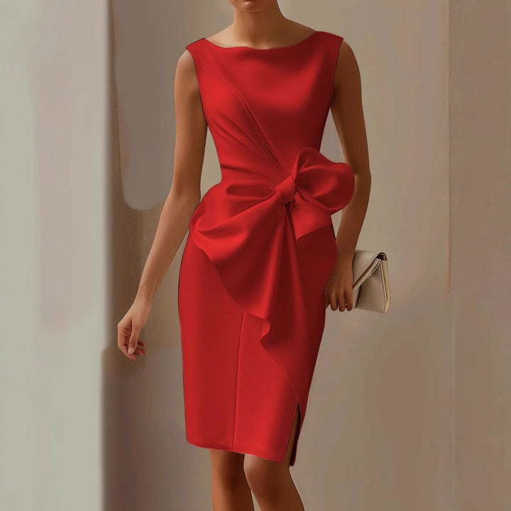 Female model in a sleeveless formal midi dress with an oversized waist bow on a plain background.