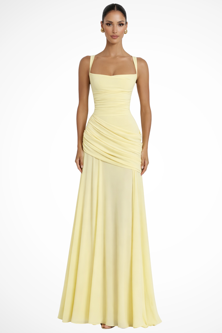 Female model wearing a square neck maxi dress with draped detailing against a plain background.