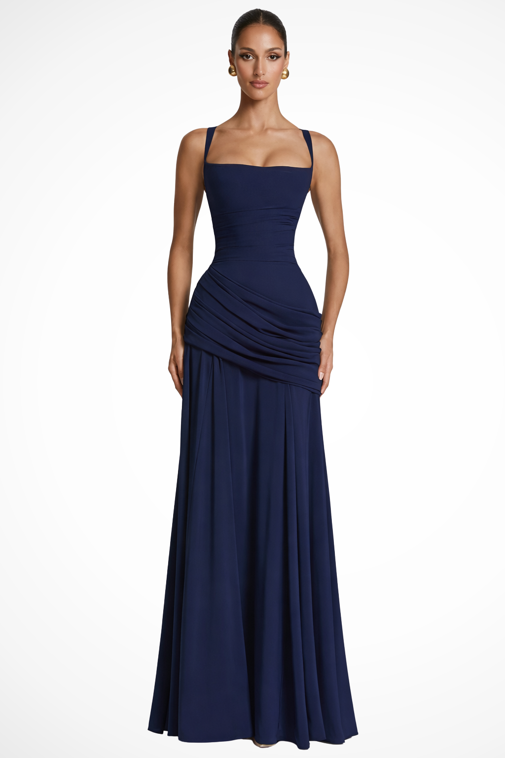 Female model showcasing a sleek maxi dress with sculpted draping and square neckline on a plain background.