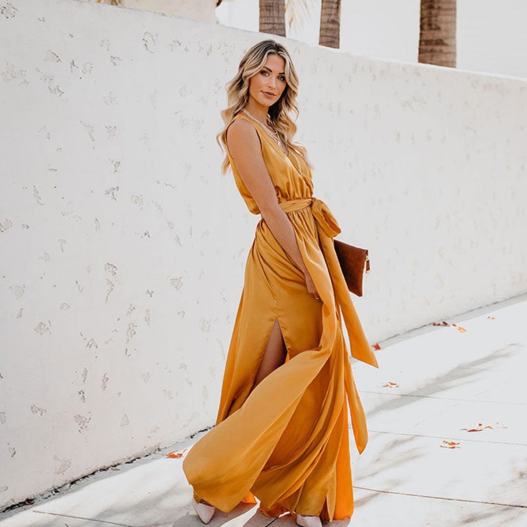 Female model wearing a graceful sleeveless maxi dress with streamlined silhouette on a plain background.