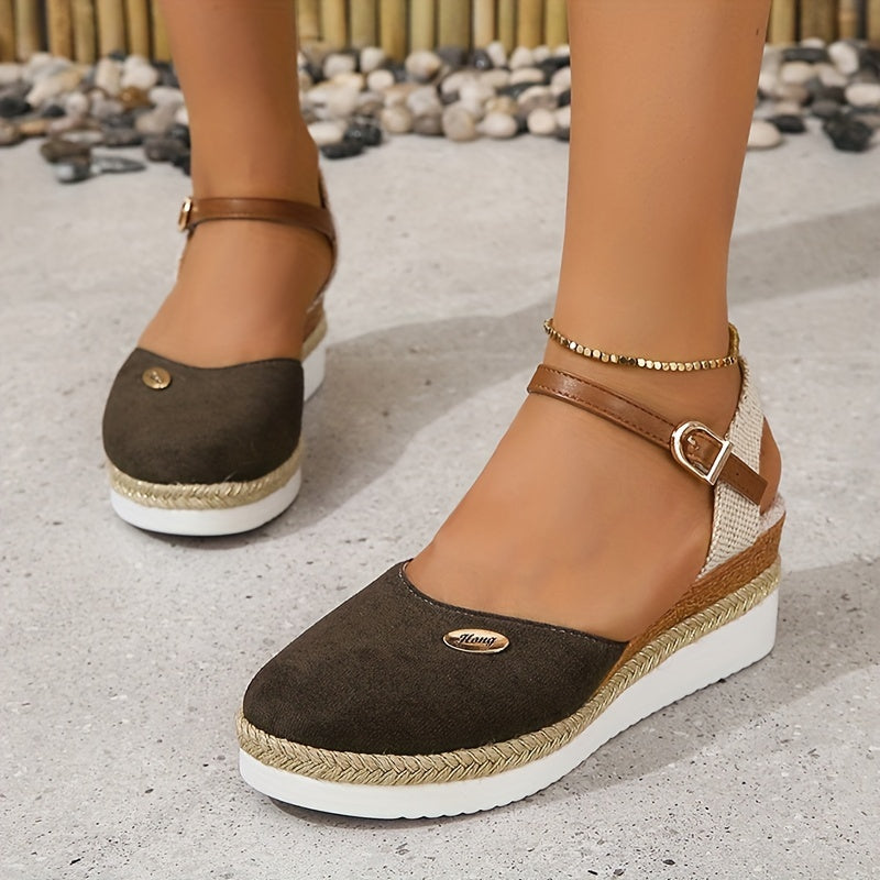 Natural stance foot in sandals against gray floor backdrop