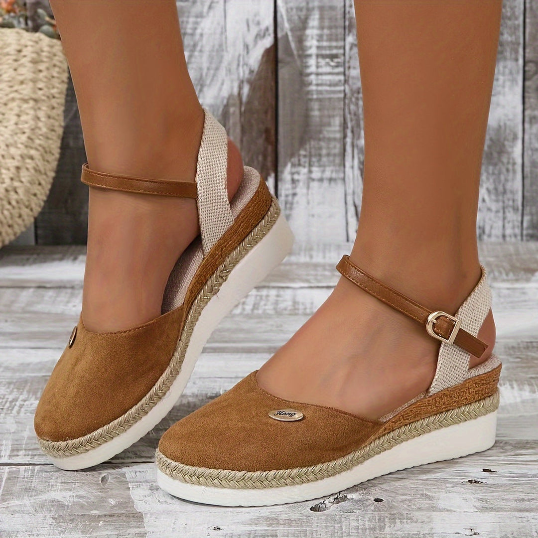 Casual pose foot in sandals against gray floor background
