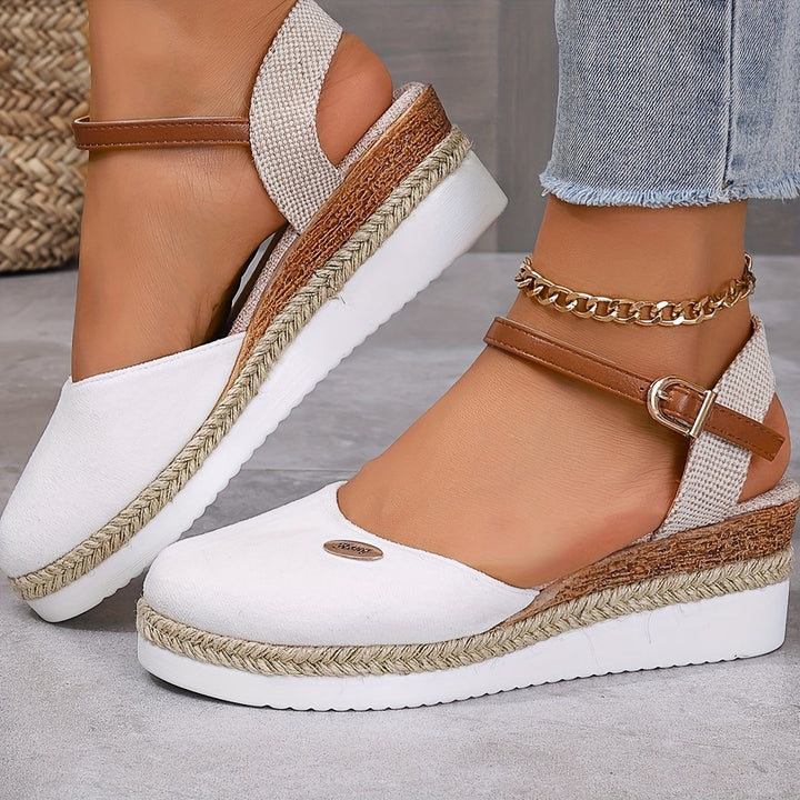 Front view foot model showcasing closed toe sandals gray flooring background