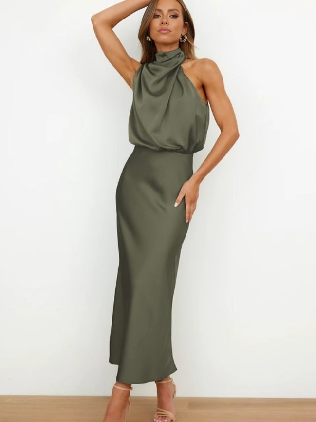  Woman wearing a flowing formal dress designed for special occasions on a plain background.