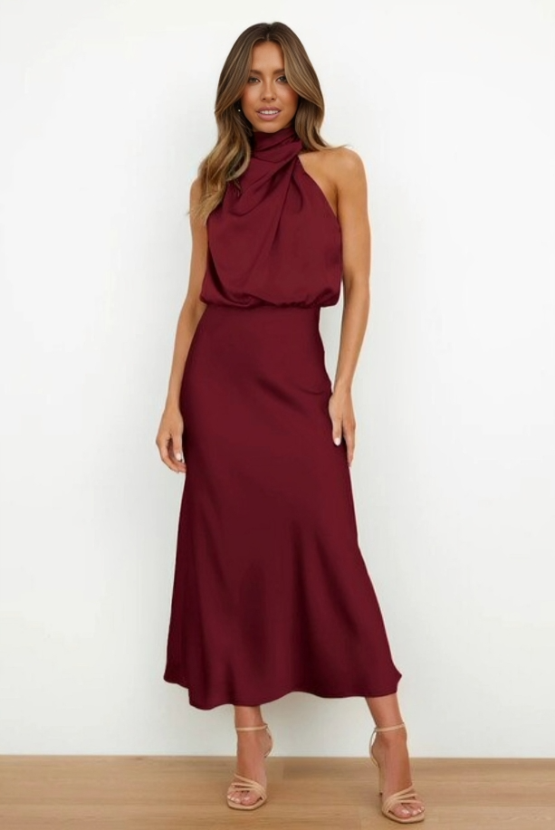 Flowing satin eveningwear displayed against a simple plain background.
