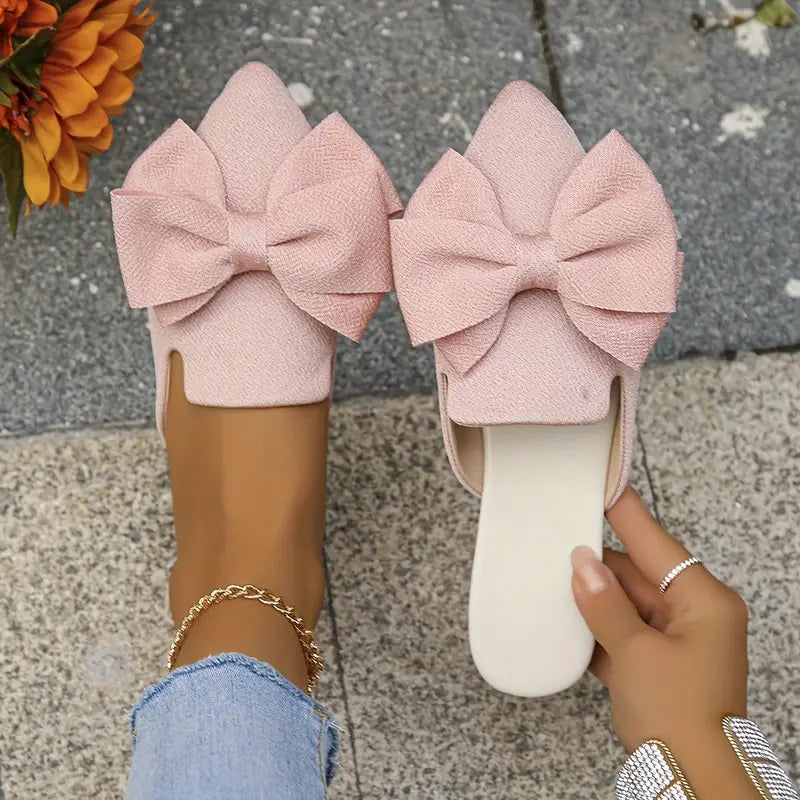 Front angle highlighting sleek pointed toe and bow accent