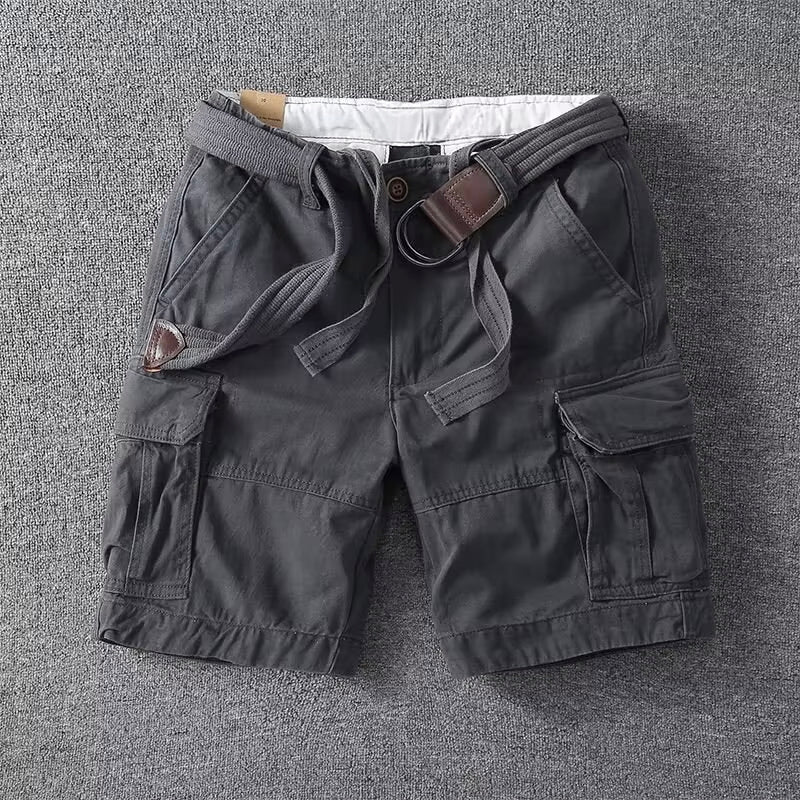  Man wearing utility cargo pants against a simple plain backdrop.
