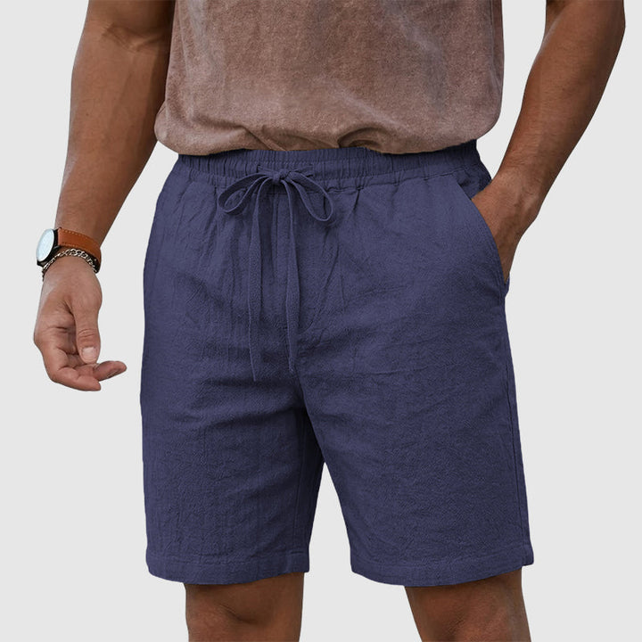 Male model wearing casual shorts on a plain background.