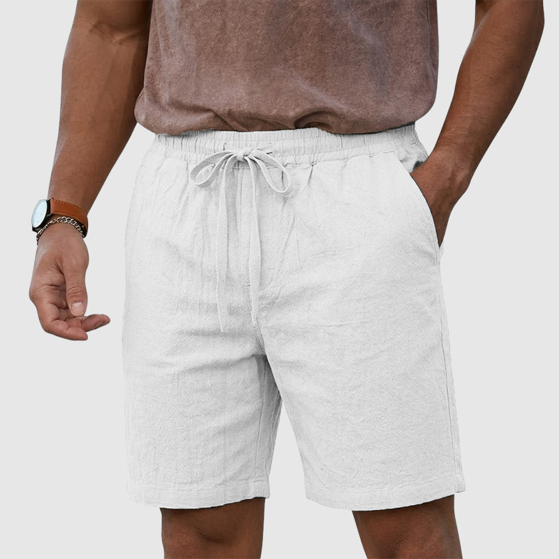  Male model showing lightweight casual shorts on a plain background.
