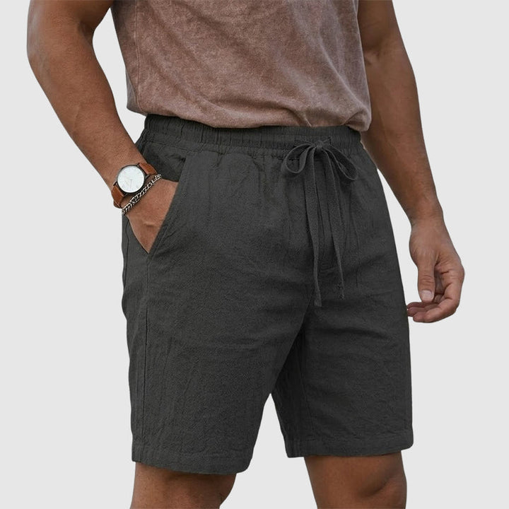  Model wearing warm weather casual shorts on a plain background.