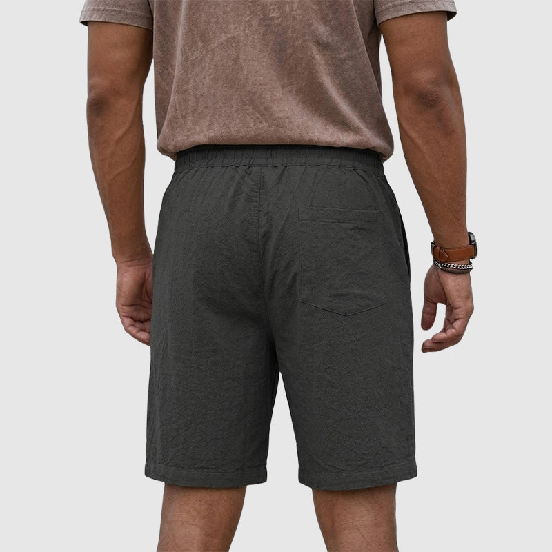 Male model showing men’s shorts with a flexible waistband on a plain background.