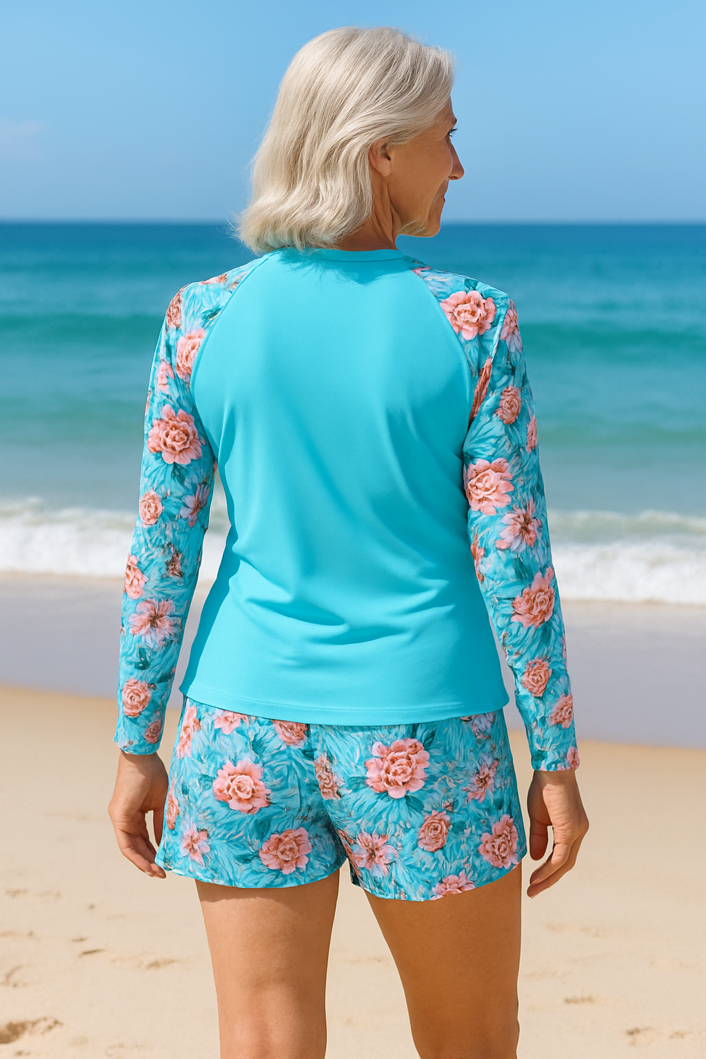 Woman wearing a flattering tankini near a soft beach setting, back angle