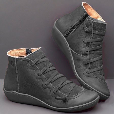 Pair of gray high-top sneakers on a gray background