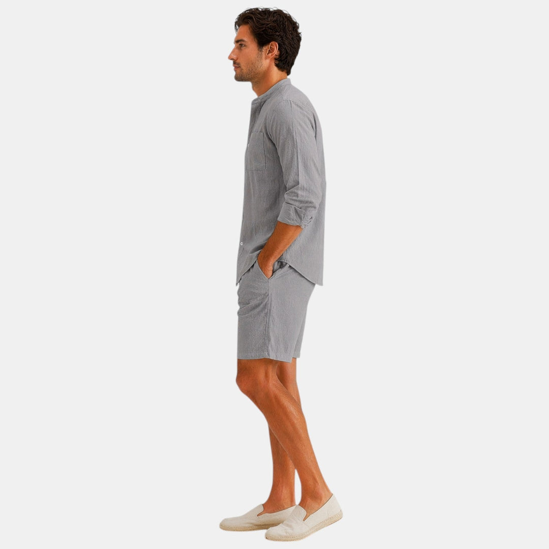  Male model standing in a casual two piece outfit with a clean plain background.
