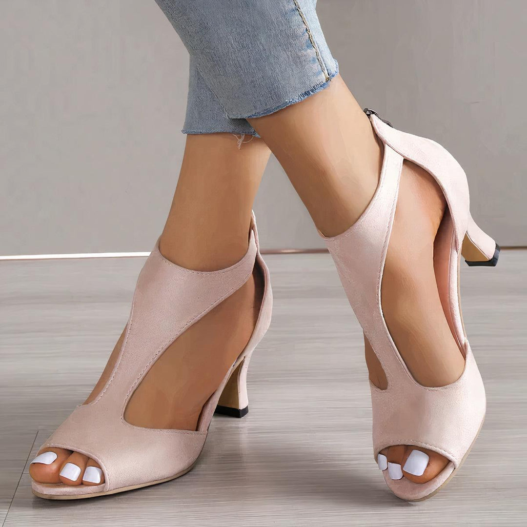 Angled perspective heel sandals highlighting arch support plain background