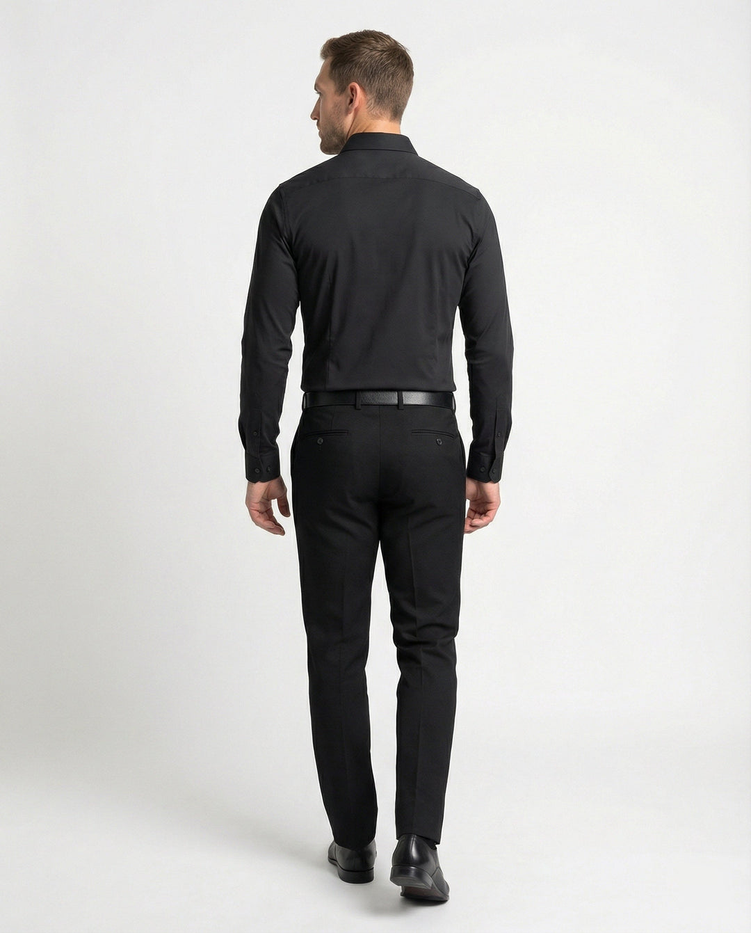 Male model wearing a refined office shirt on a plain background.