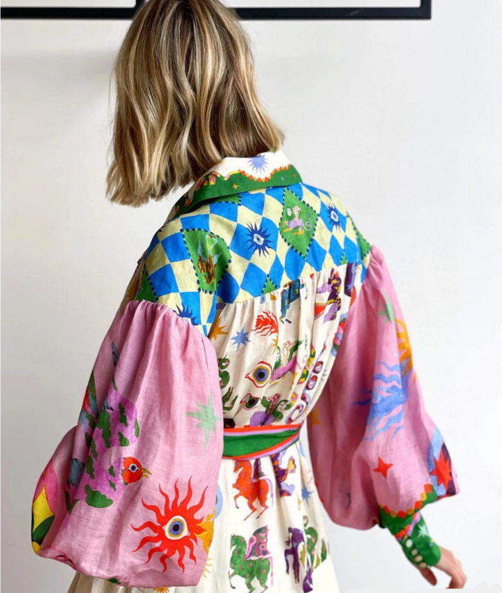 Back view, model in an effortless summer maxi dress with a flattering twist front design.
