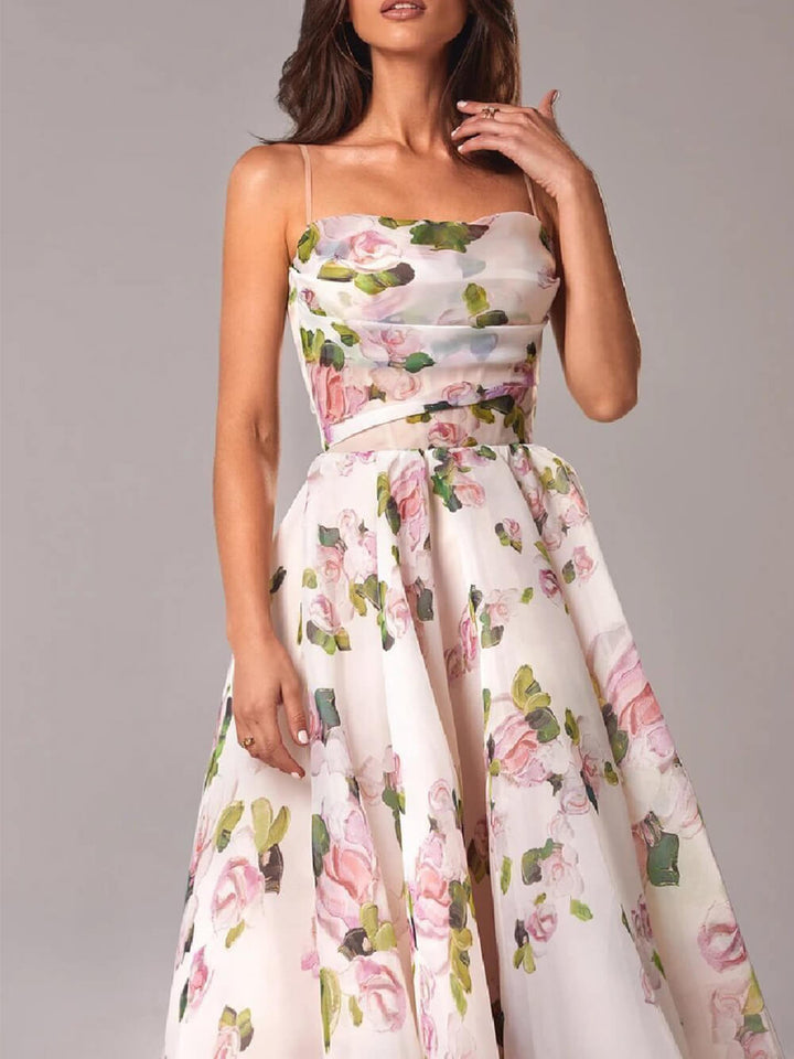  Woman displaying a lightweight floral dress with a feminine design on a plain background.