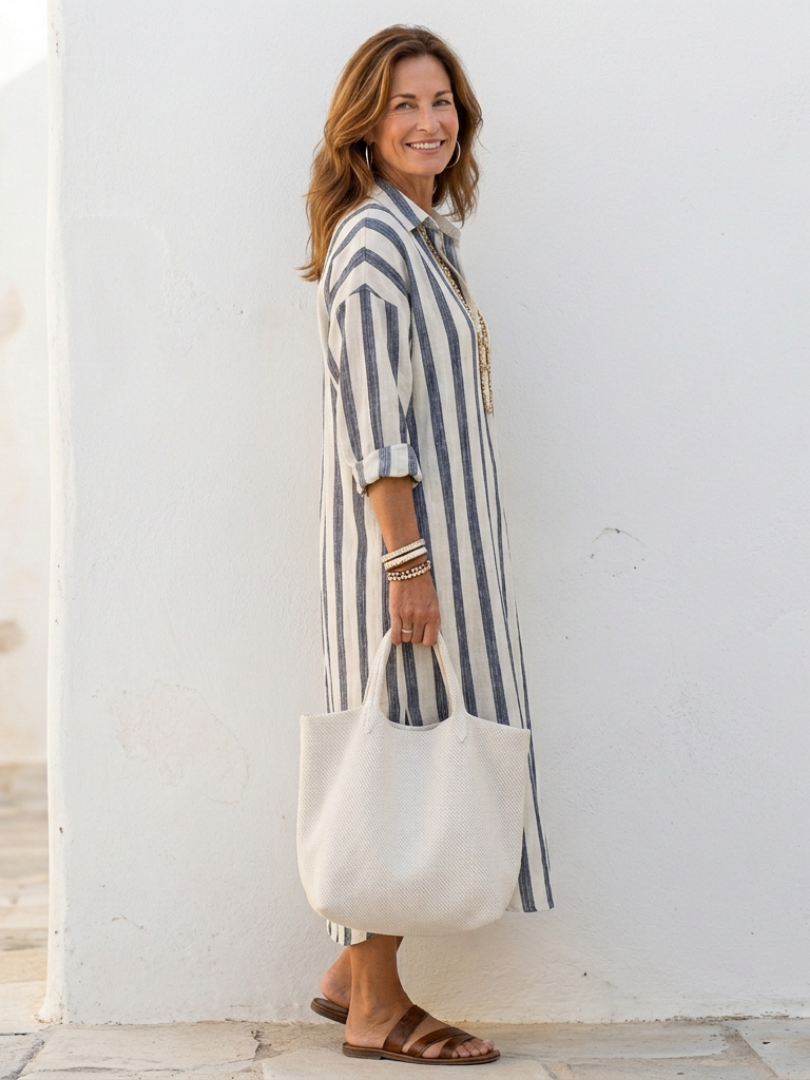 Female styled in a long sleeve layered outfit with a front closure on a plain backdrop.