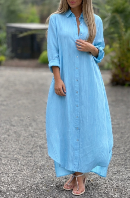 Model wearing an oversized maxi shirt dress with button-front on a clean background.